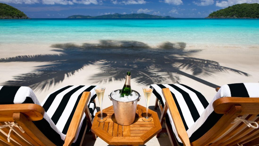 luxury beach chairs with champagne on a shoreline